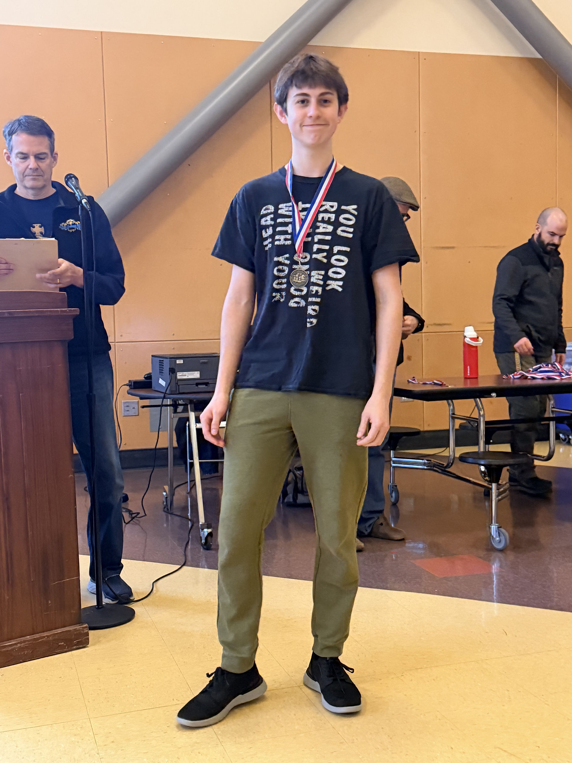 A student smiling with a medal.