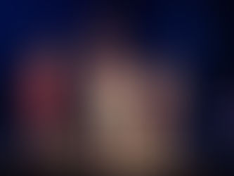 Theater scene with three actors in various poses on black steps. Multiple actors in background. Plastics scene in Mean Girls.