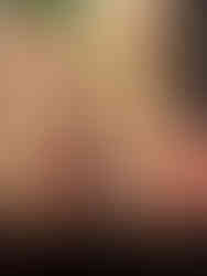 Mean Girls Africa scene. Three actors wear animal print onsies. The fourth actor sits in a chair surrounded by the actors. There is an orange striped tent beside them. An African painted scene in the background.