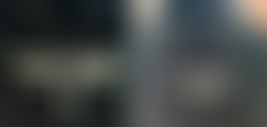 Silver dragonfly necklace with blue gemstone on black velvet stand highlighting intricate wing details.