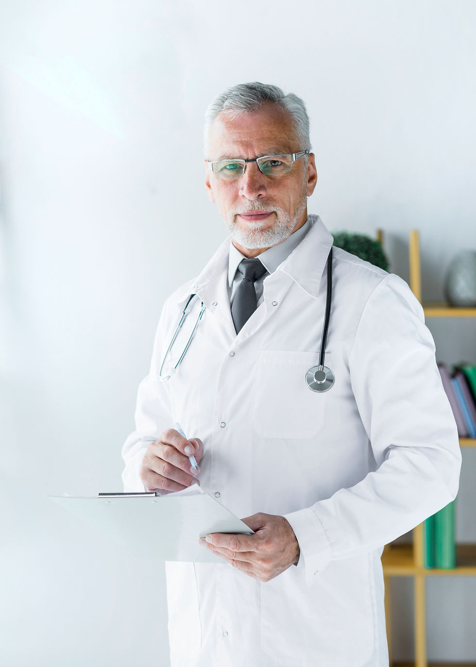 Doctor wearing a white coat with stethoscope, holding medical records About Medical Care Centre