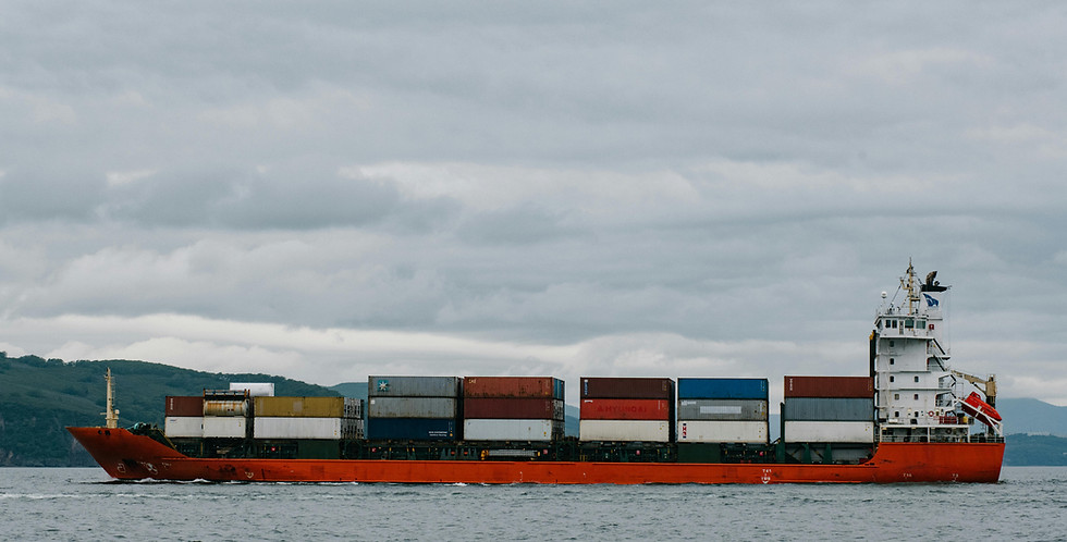 Aerial view of a massive cargo ship navigating through a ship.