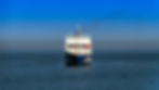 massive cargo ship navigating through the blue ocean waters.