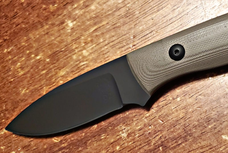 Matte black Cerakote finished knife blade on wood surface. - LR - Series