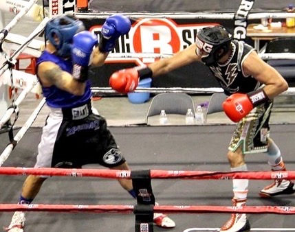 Masters boxer with hand raised in victory after tournament fight.