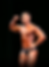 Dustin smiling and posing on stage during a bodybuilding competition