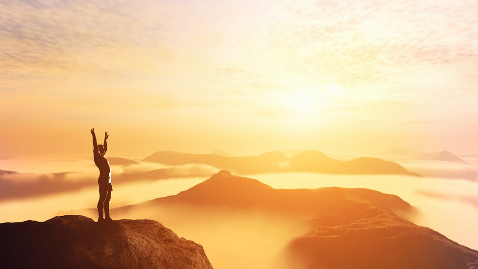 Silhouette of person with raised arms on mountain peak at sunrise, symbolizing wellness and mental clarity