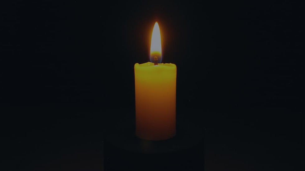 A gentle candle glowing in memory of a cherished pet