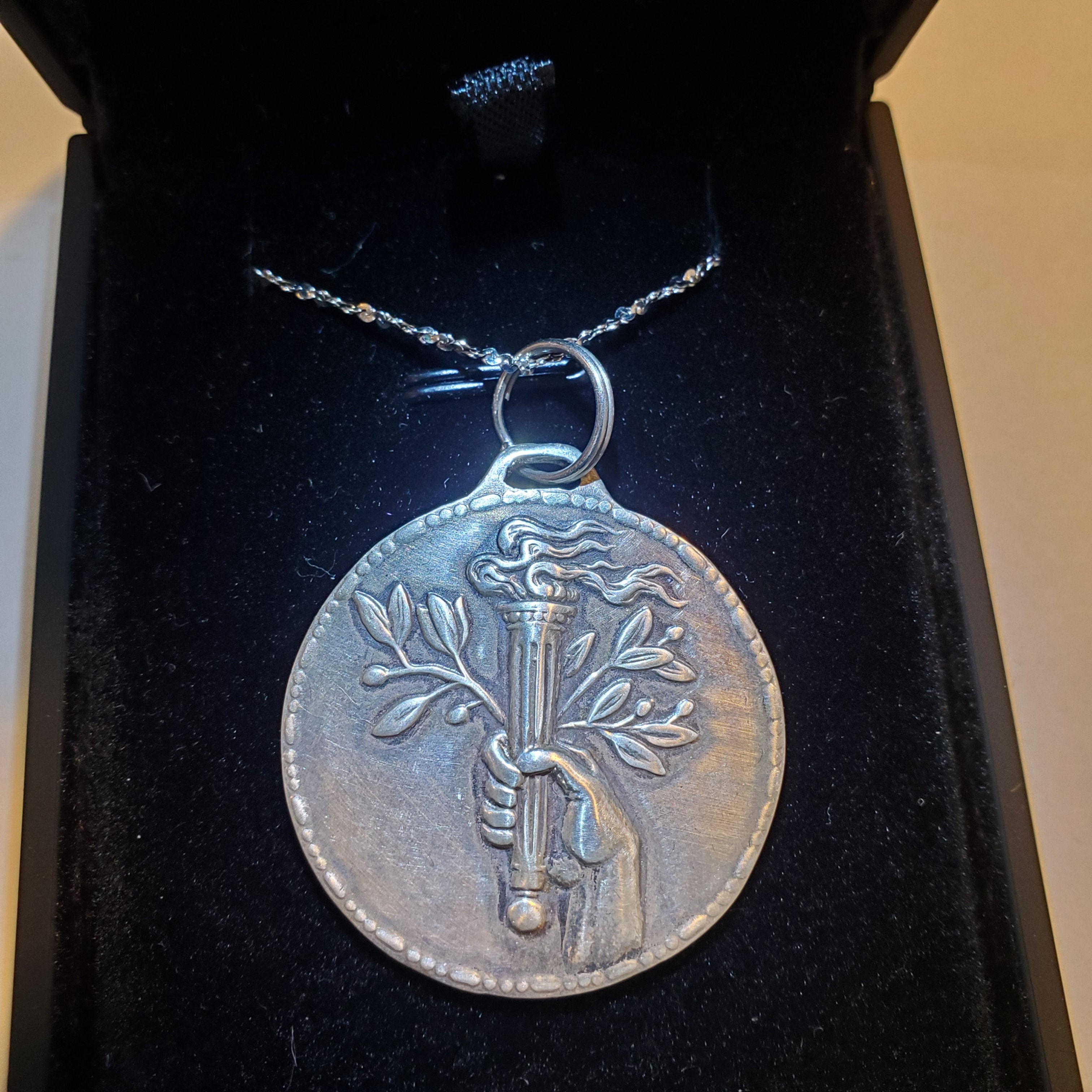 Hand cut Victory's Torch Sterling Silver pendant