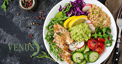 Plate of colourful, healthy balanced food including chicken, salad and brown rice.
