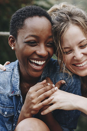 Two women laughing and embracing