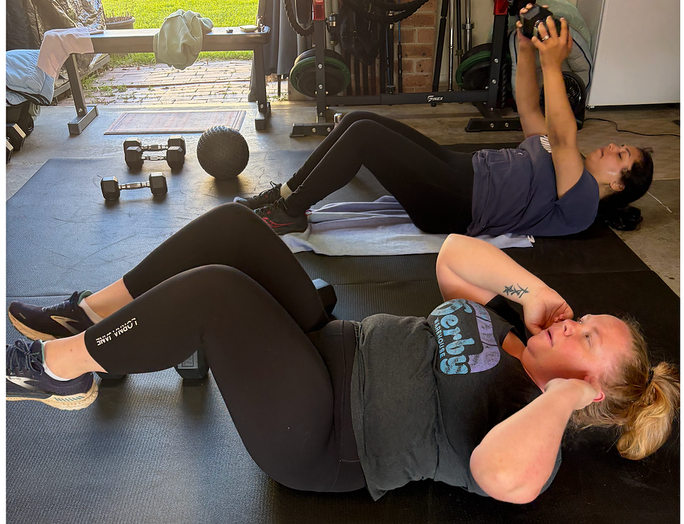 Two women at Buddy Personal Training session doing crunches