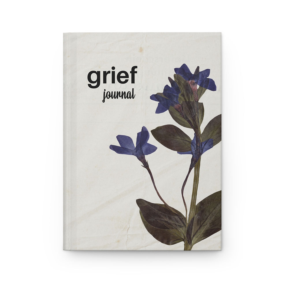 Guided Grief Journal open on a table with a pen beside it, ready for writing
