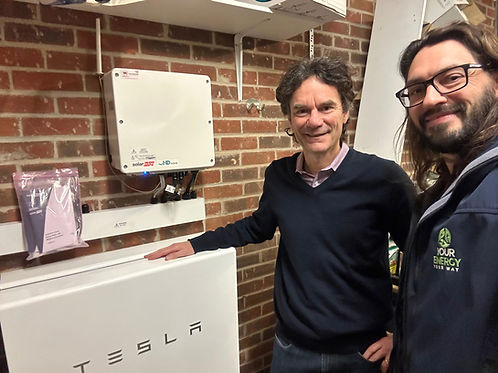 Customer and YEYW director next to a newly installed Tesla Powerwall