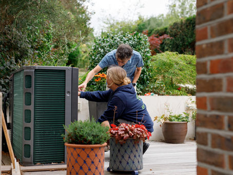 Heat Pump Engineer and customer in front of a Samsung R290 heat pump
