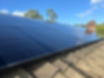 A close up of a solar PV installation with bird blocker running along the outside edge