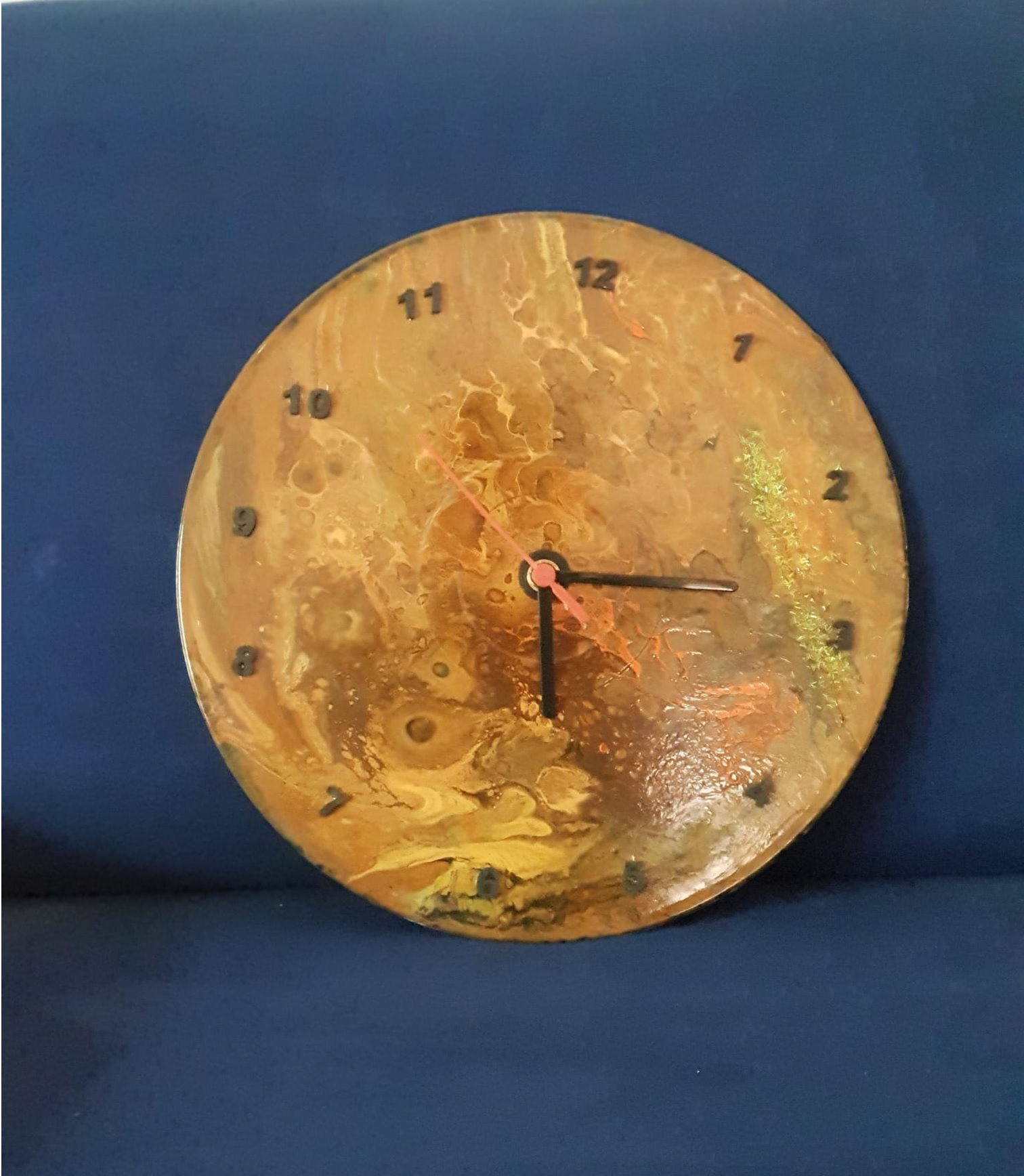 Wall clock on a record painted in the Fiornig technique in shades of ocher yellow