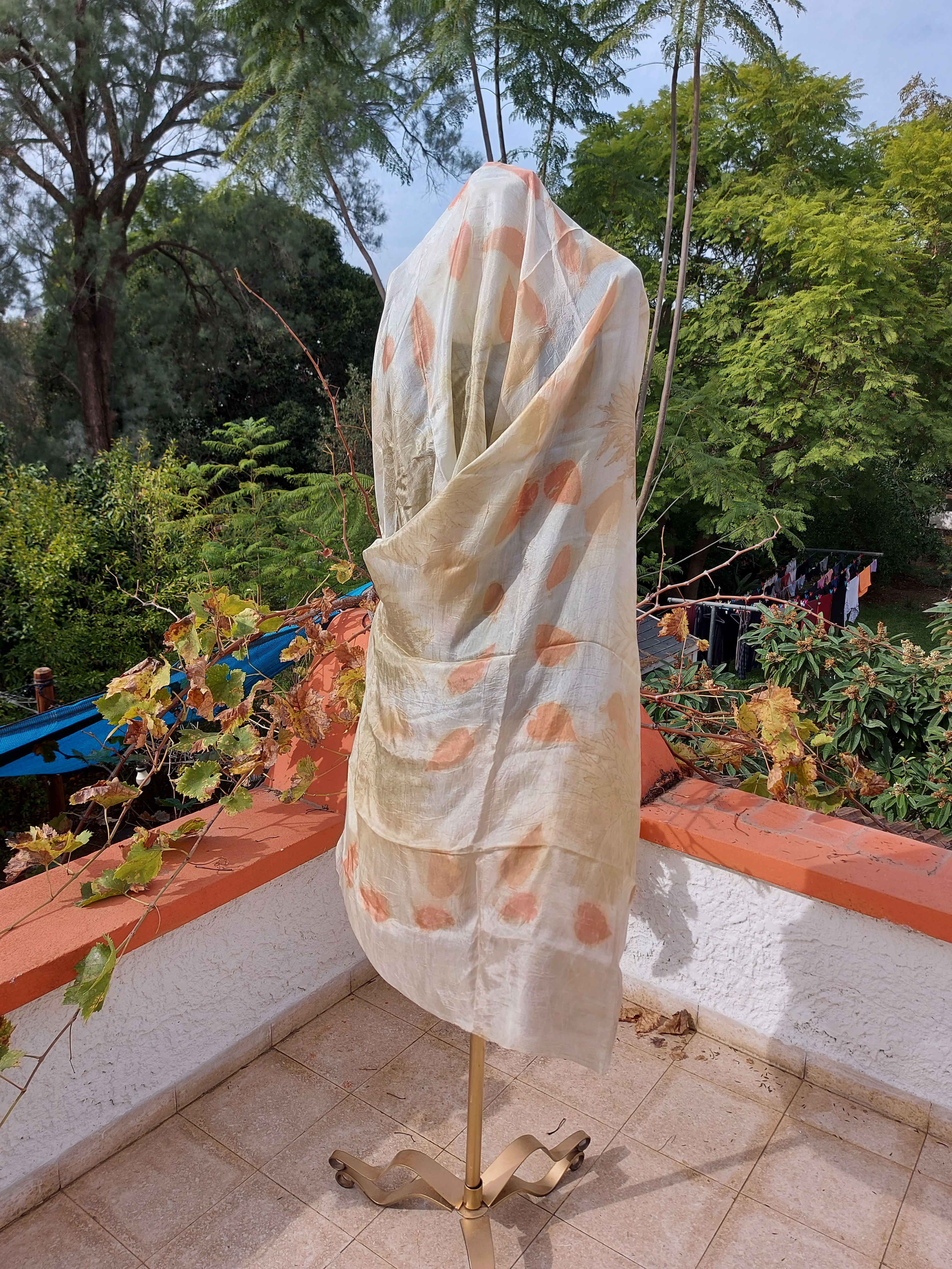 A yellow and orange silk scarf on a doll model