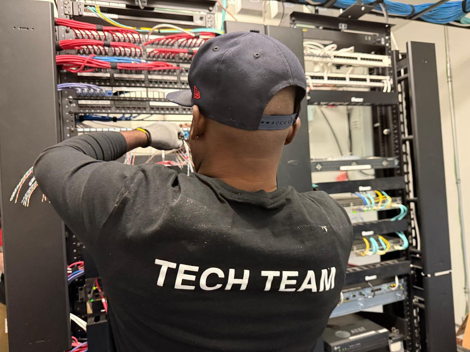 Unio Tech employee organizing low voltage cables in a server room