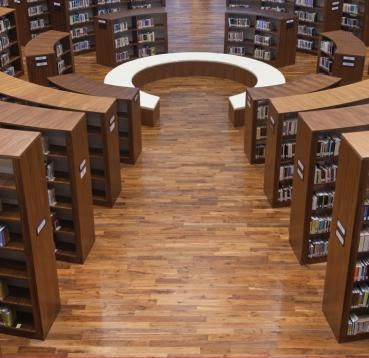 Hardwood flooring and book shelves in a library made from Walnut.