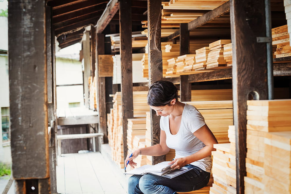 A woman looks through her notes at a hardwood retailer selling genuine Matson hardwood lumber.