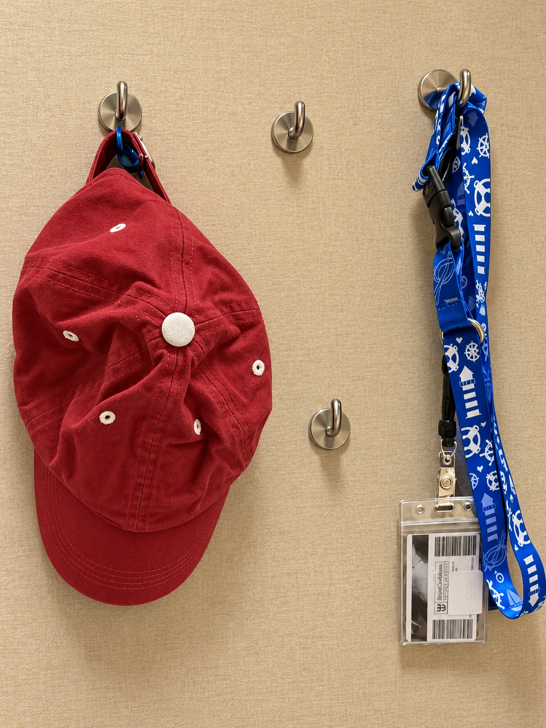 Magnetic hooks holding lanyards and a waterproof pouch in a cruise stateroom