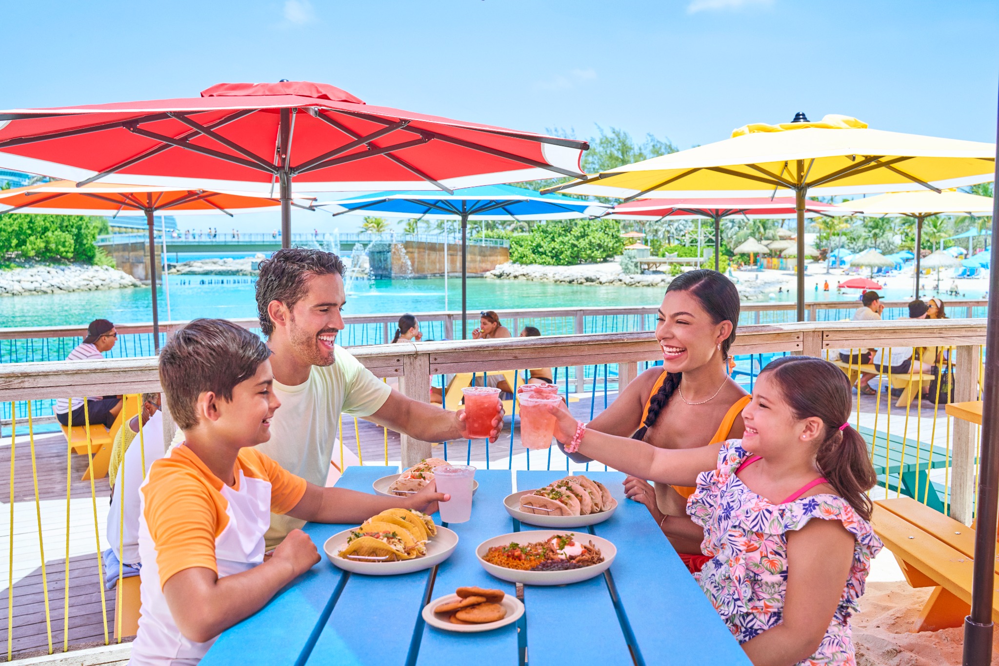 Family sharing a meal at a picnic table at Perfect Day at Coco Cay