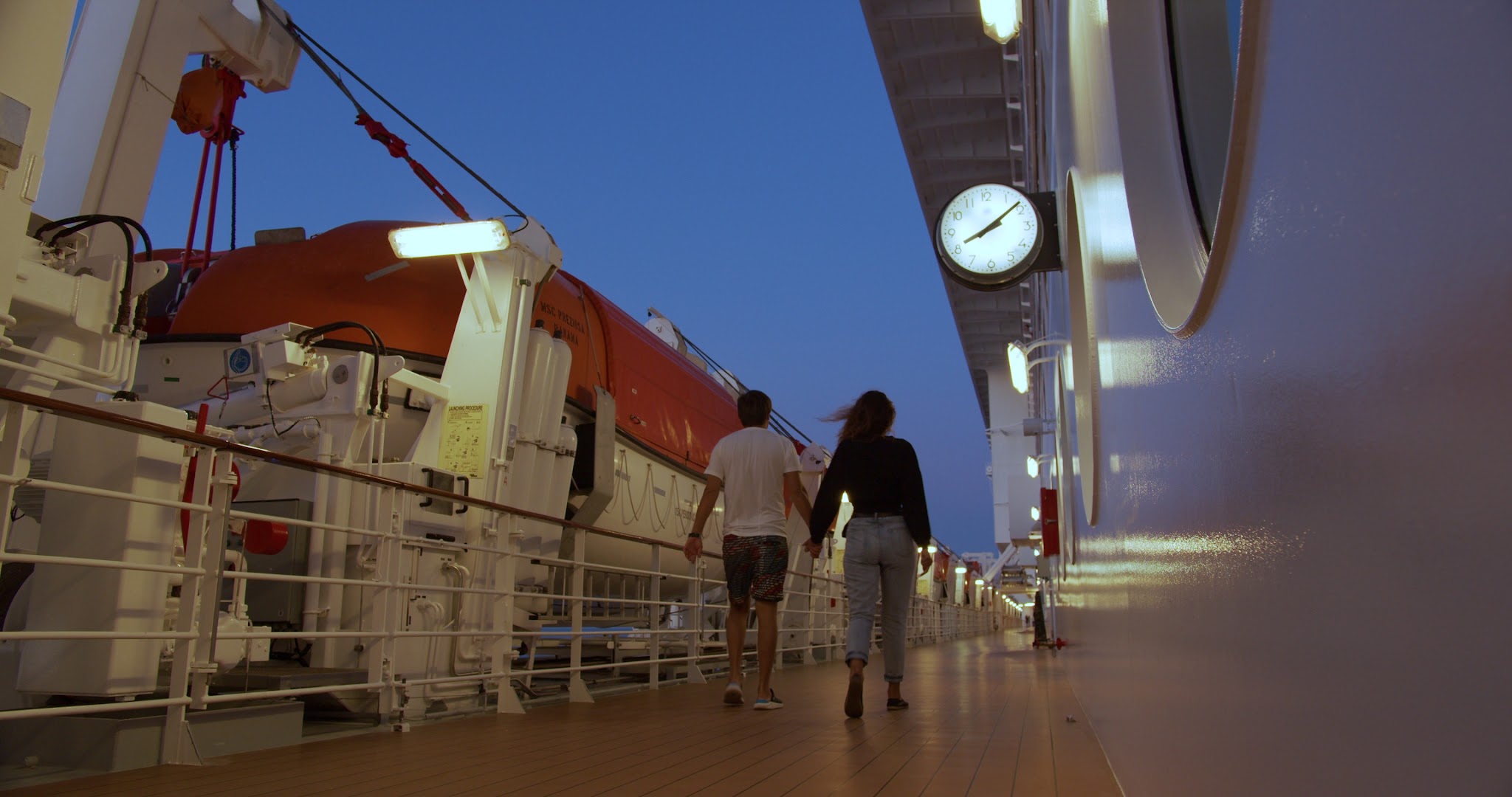 Couple strolling on the deck of a cruise ship