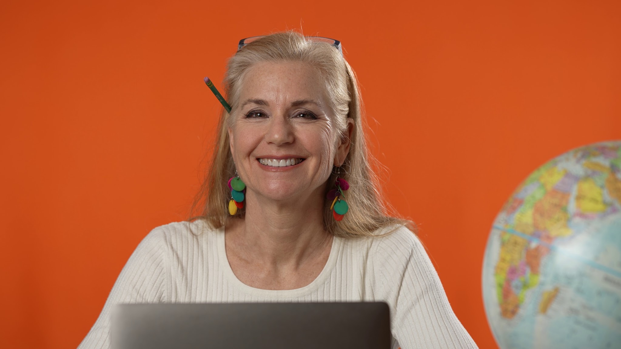 Travel consultant at a desk holding a globe
