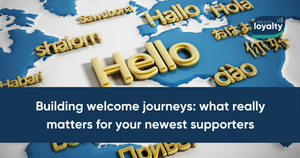 A map of the world with 'Hello' in different languages spread across it. The article title is 'Building welcome journeys: what really matters for your newest supporters'