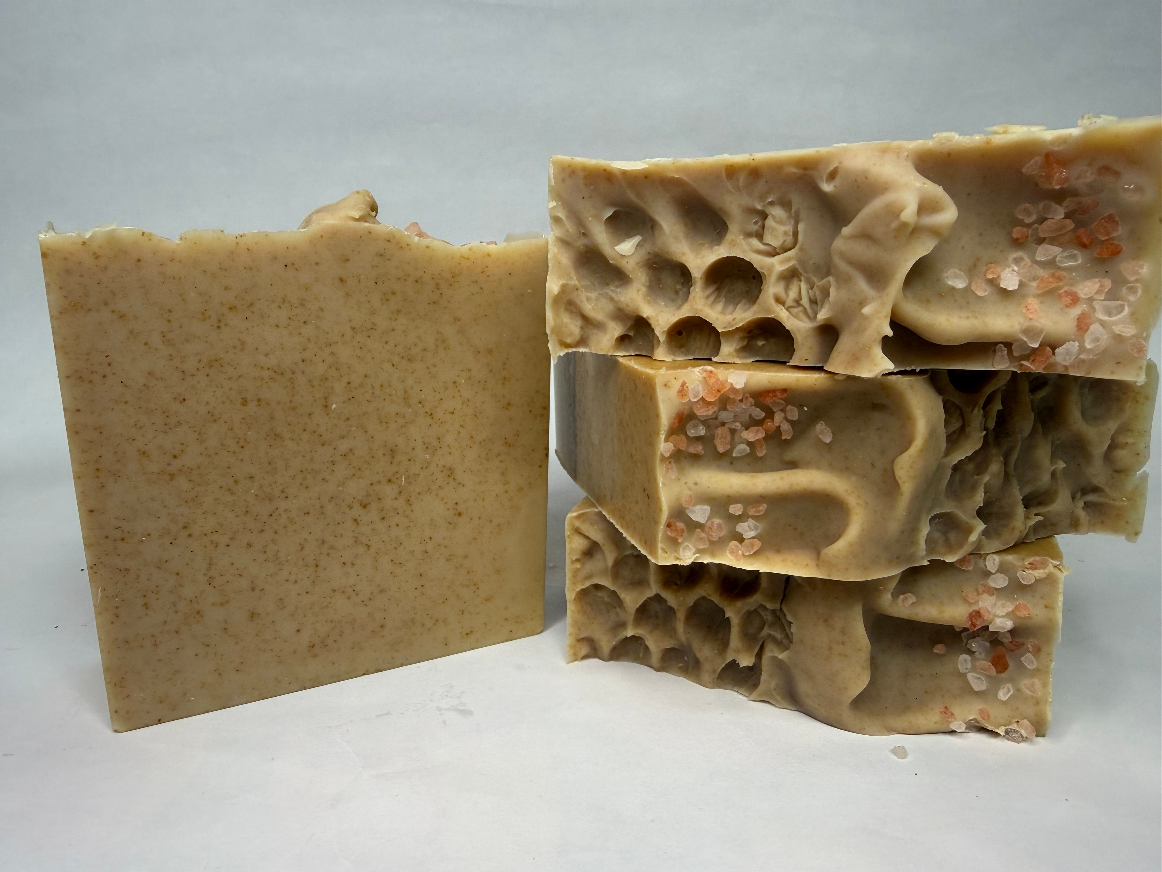Oat colored bars of soap with honeycomb design detail and pink Himalayan salt sprinkle. Scent of oatmeal and honey.