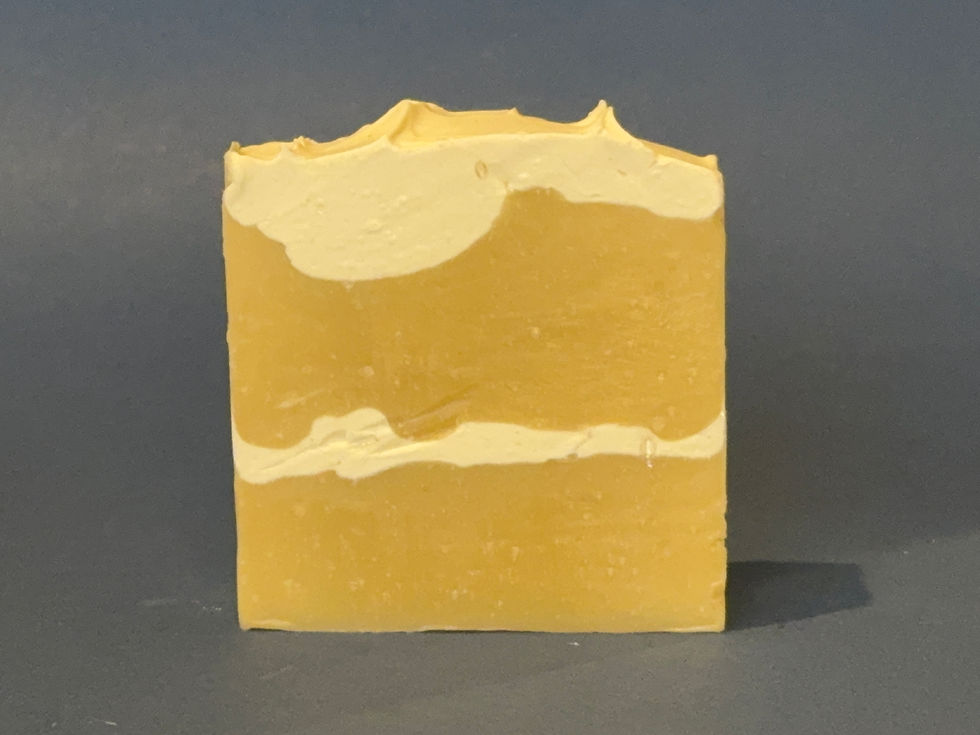 Butter yellow and cream colored soap bar fashioned after a chiffon cake with orange and lemon citrus notes