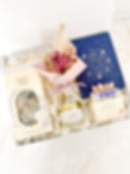 Wrapped With Care gift box with night time tea, rose and oud candle, thought a day journal, handmade soap and dried flowers.