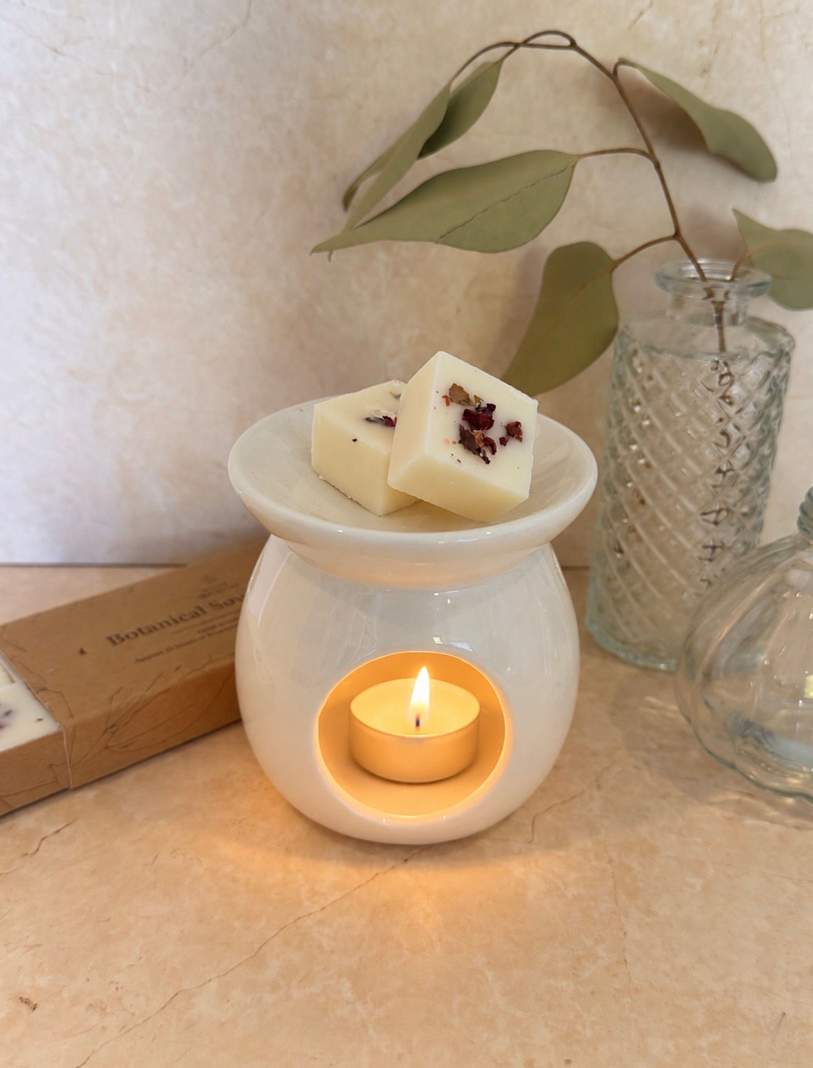 White ceramic wax melt burner with tealight and botanical wax melts