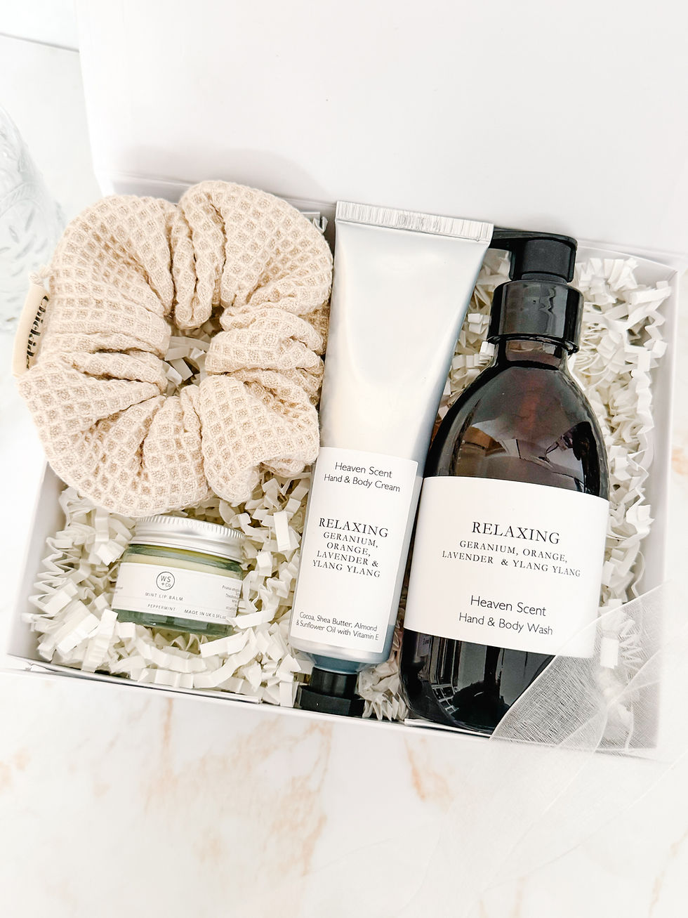 Relaxing Rituals gift box with relaxing hand and body wash, hand and body cream, peppermint lip balm and soft neutral scrunch