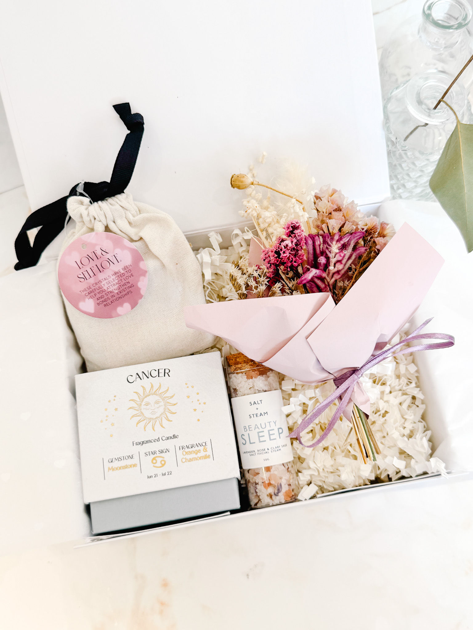 Cancer Season Gift Box with zodiac candle, crystal pouch, bath salts and dried flowers in luxury white gift box