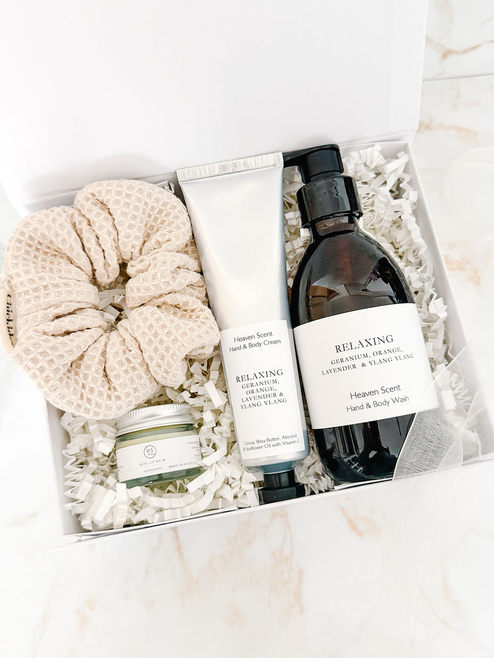 Relaxing Rituals gift box with relaxing hand and body wash, hand and body cream, peppermint lip balm and soft neutral scrunch