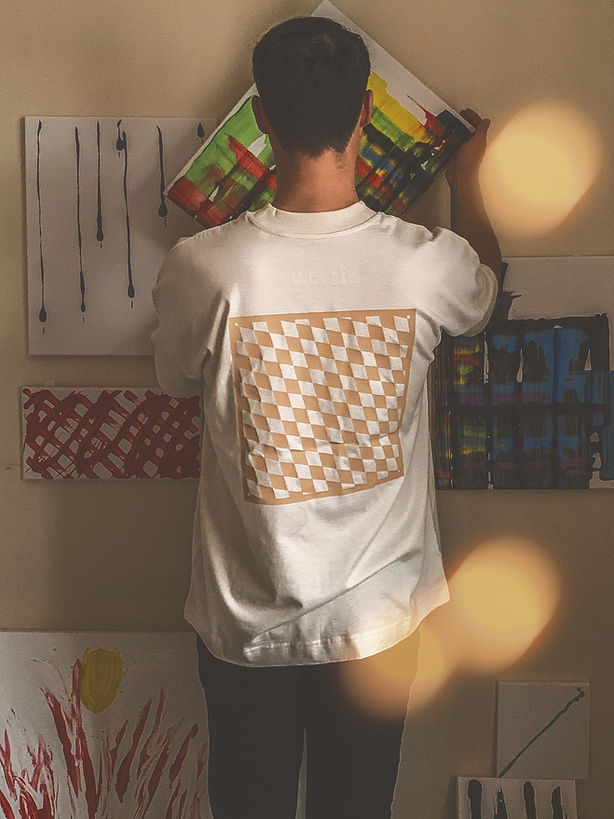 Person wearing Inside The Box Clothing Classics 001 Natural Raw Oversize T-shirt and hanging up paintings