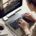 photorealistic photo of a woman on a laptop computer writing a novel.jpg