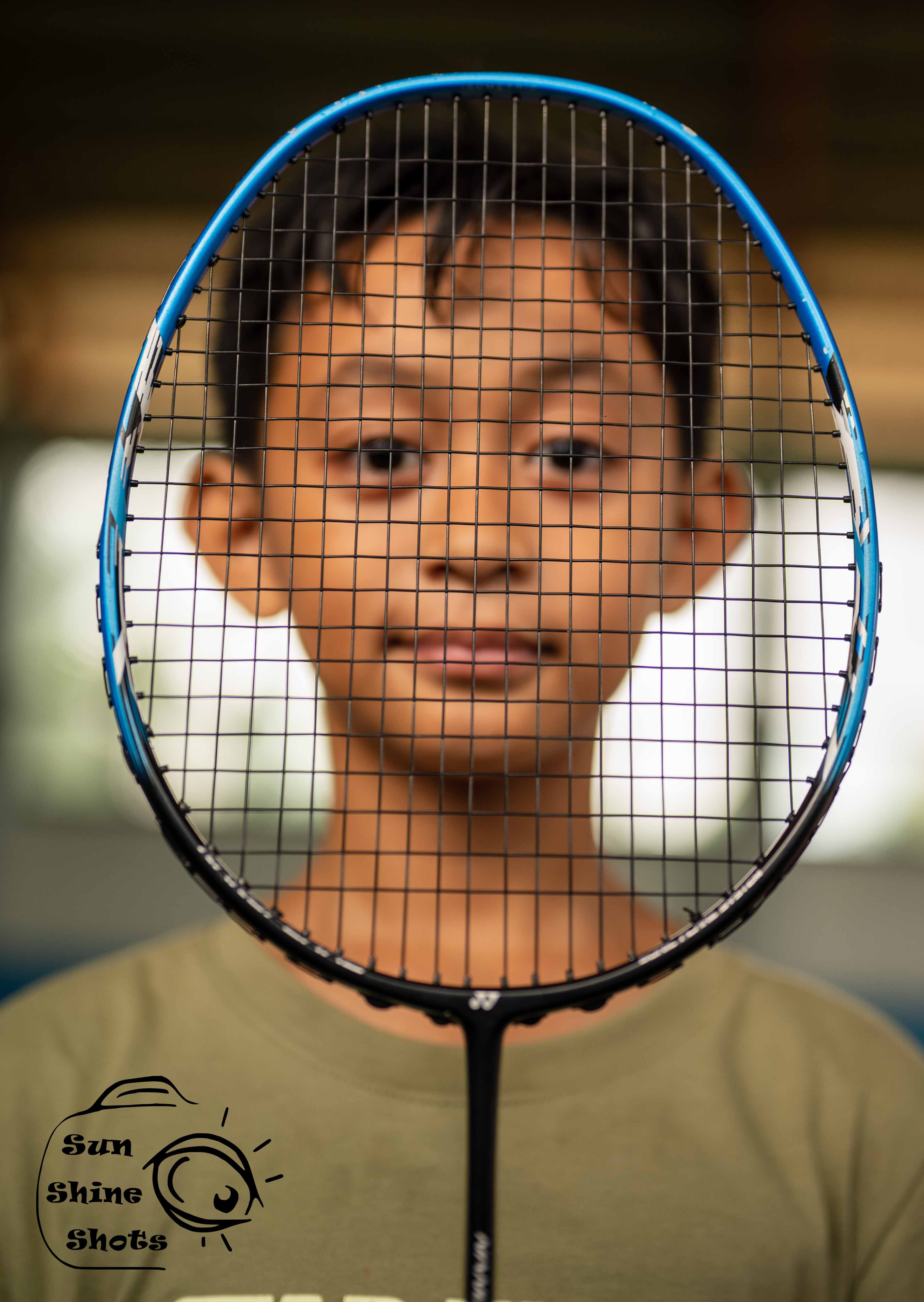 Pilipino boys face behind a tennis racket
