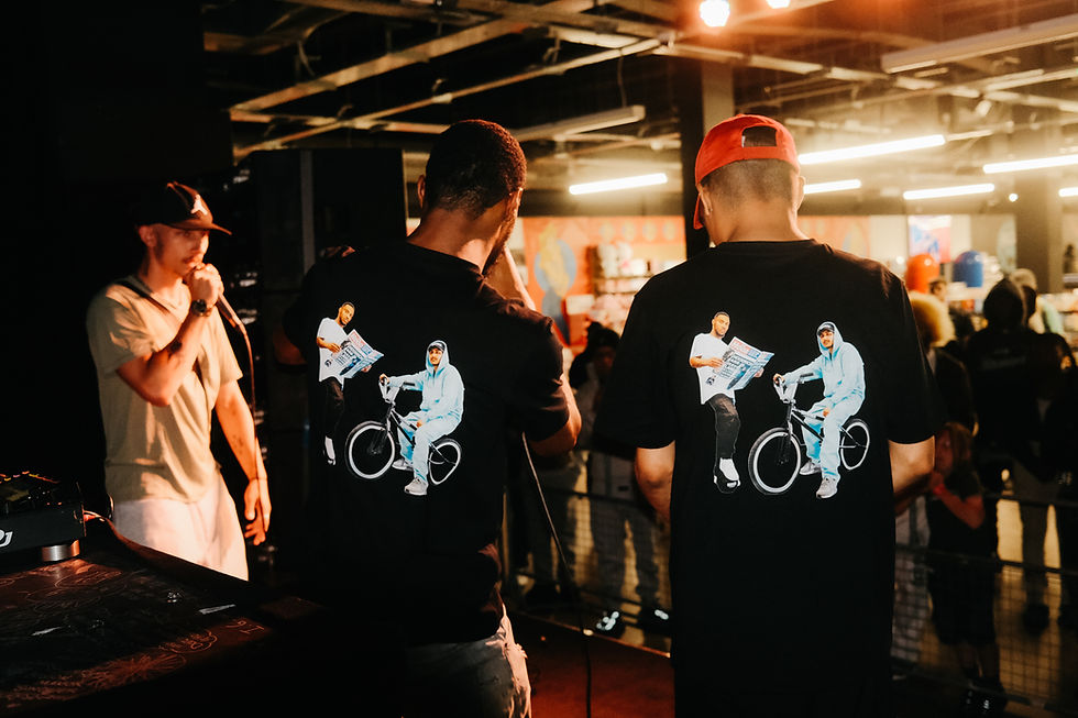 Two men wearing Champion Season T-shirts, onstage at a concert. Parlay Records.