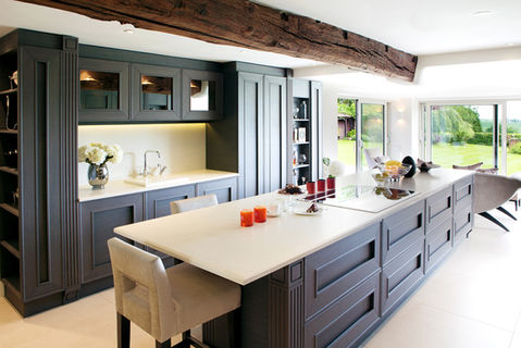 Traditional-meets-modern kitchen renovation in Warwickshire, showcasing shaker-style cabinetry, quartz worktops, integrated appliances, and exposed oak ceiling beam. Part of a ProBuild360 refurbishment project blending period charm with contemporary functionality.