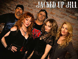 Five adults in black pose against a brick wall under JACKED UP JILL, with rock-band style and confident smiles.