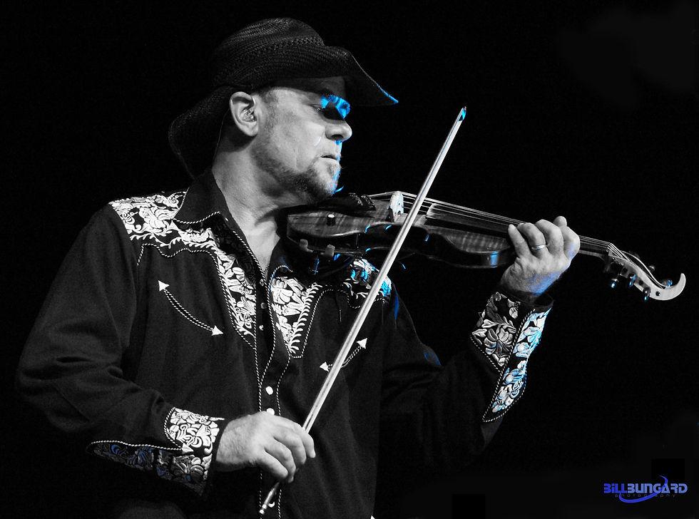 Cowboy-hatted violinist, Geoffrey Castle, in black embroidered shirt plays on a dark stage with blue highlights; BillBungard Photography watermark.