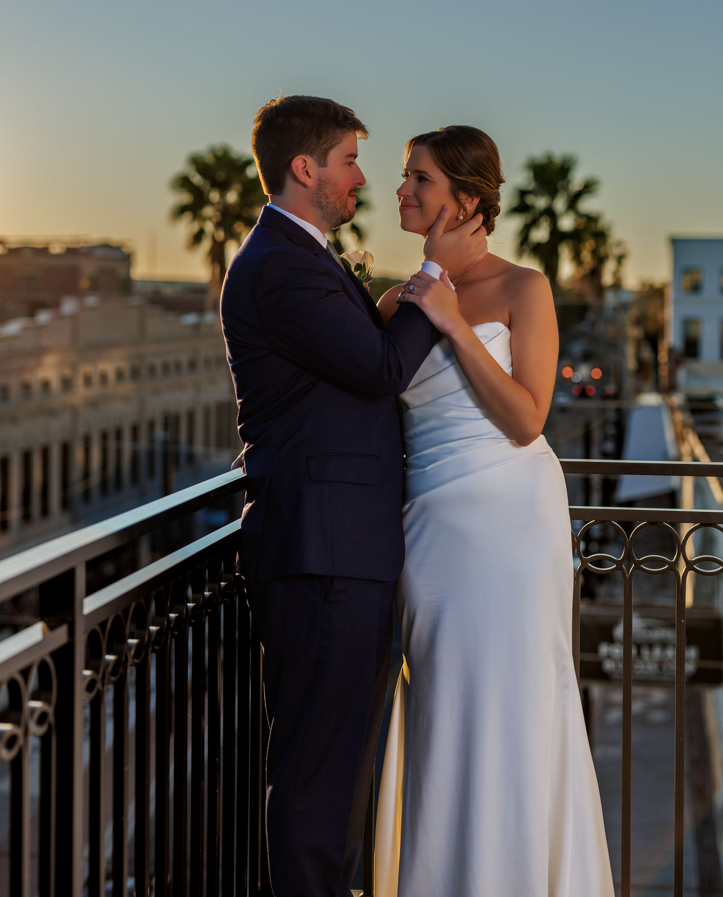a bride and groom are posing for a picture on a balcony