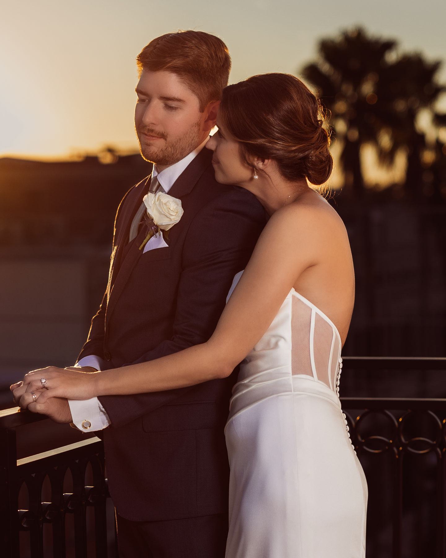 a bride and groom are posing for a picture on a balcony