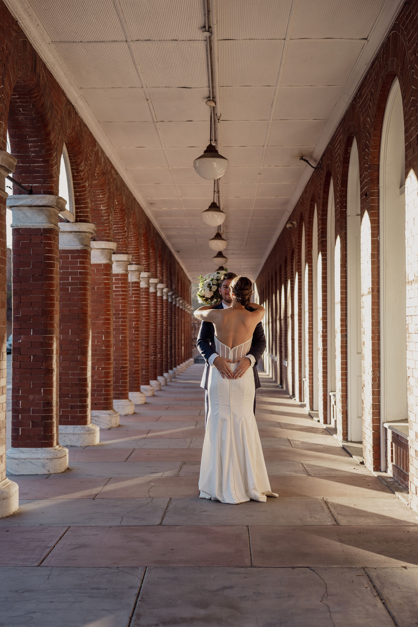 a bride and groom are posing for a picture in an archway