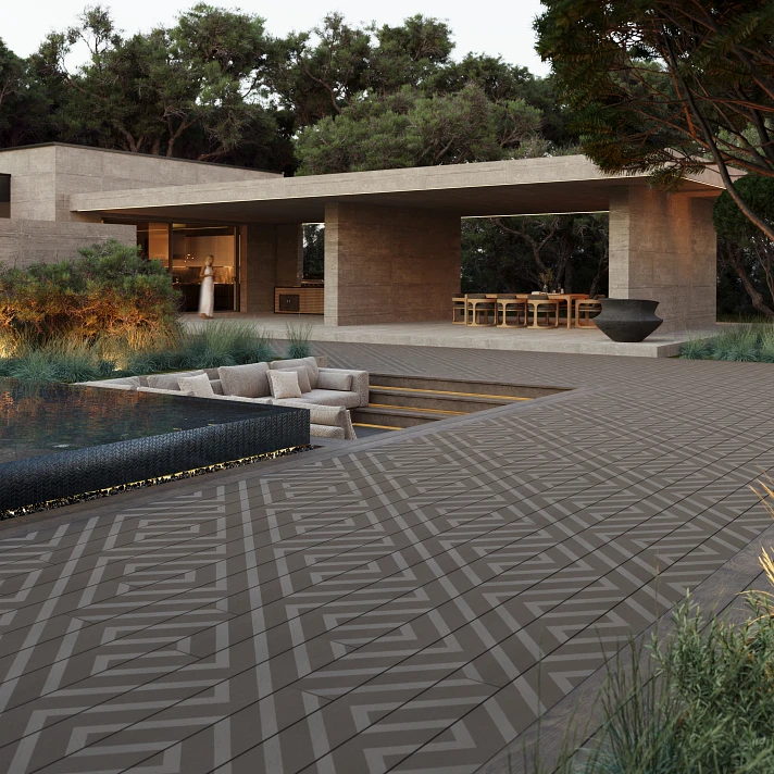 Grande terrasse moderne avec motifs géométriques foncés près d'une piscine.