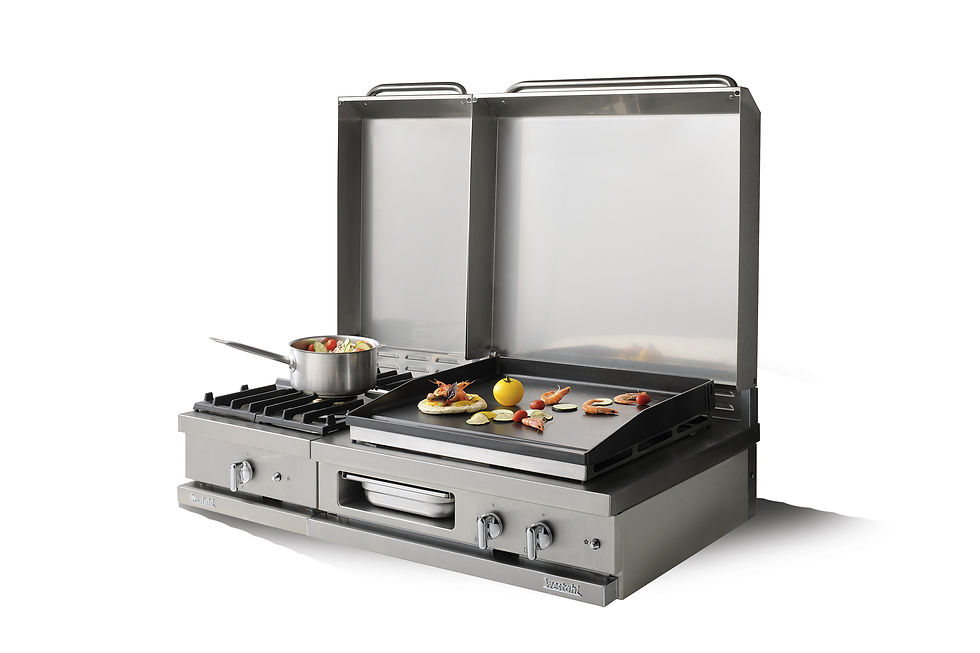 Table de cuisson Lacanche Open’Cook combinant brûleurs gaz et plancha en fonte émaillée, capots inox relevés — une configuration phare pour nos cuisines extérieures WAHO.