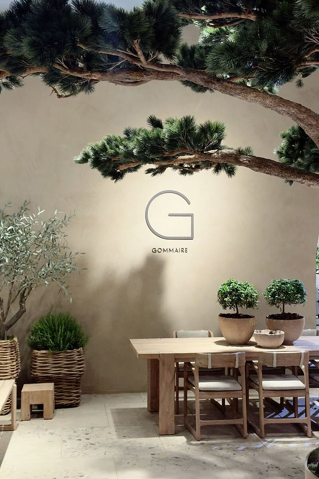 Scénographie inspirée d’un jardin méditerranéen mêlant mobilier en bois naturel, végétation et matières authentiques.